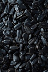 A close-up view of a pile of sunflower seeds. Ideal for food and nutrition concepts - obrazy, fototapety, plakaty