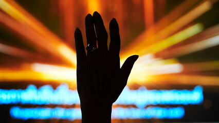 Silhouette Hand Raising Worshipper, blurred background