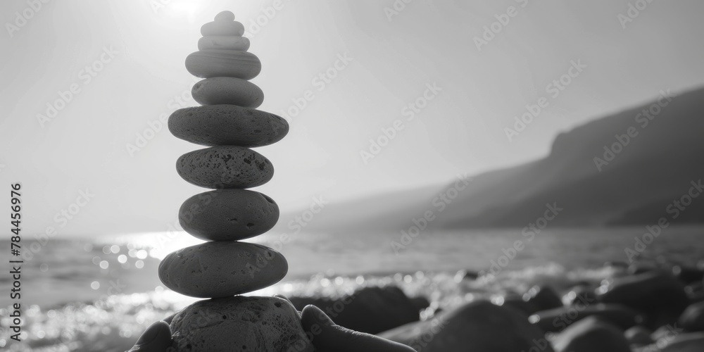 Poster a stack of rocks on a sandy beach, ideal for nature and relaxation concepts
