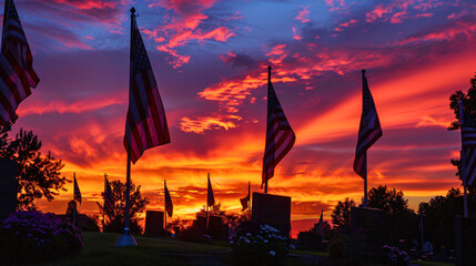 A sunset ceremony at a veteran's cemetery, with American flags silhouetted against the fiery sky. 
