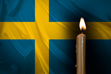 mourning candle burning front of flag Sweden, memory of heroes served country, grief over loss,...