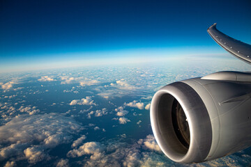 Airplane in the air, looking out with the curvature of the earth. 