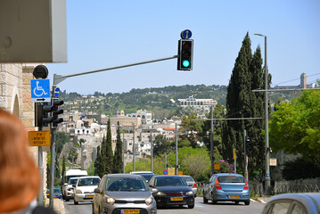 Traffic on the Jerusalem Highway, with the Old City in the background, green traffic light, Israel.