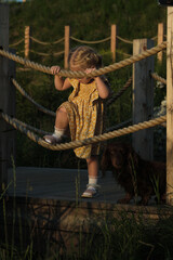 Sun-kissed child plays on rope, an image of joy and summer freedom. Evokes nostalgia and the simple pleasures of childhood.