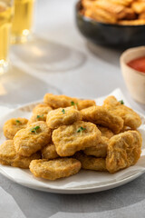 Delicious golden chicken nuggets on a plate close up. Fast food, menu.