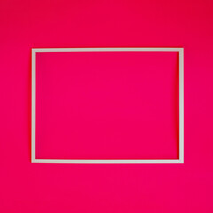 Blank white photo frame on pink background creative background concept.
