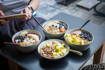 Assortment of different smoothie bowls and porridges with fresh toppings.