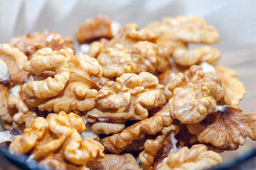 Shelled nuts background. Walnuts in a plate 