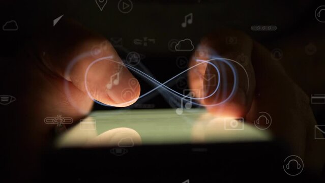 Cg animated mathematical symbol of infinity against the background of fingers using a smartphone in the dark and icons with queries of everyday life. The concept of inclusiveness of social networks.