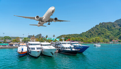 Tourist boats in the bay at the pier of tropical islands with a passenger plane taking off. Travel concept view trip vacation on exotic islands - obrazy, fototapety, plakaty