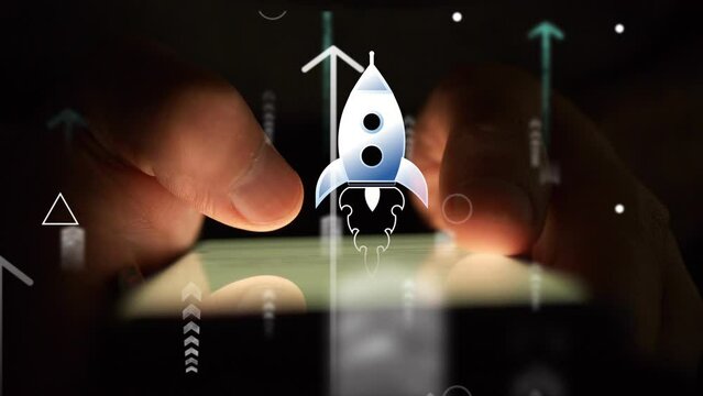 An animated flying rocket and arrows moving upward against the background of a glow-in-the-dark smartphone screen being used by a person. Cg