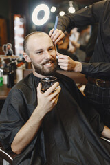 Stylish man sitting in a barbershop