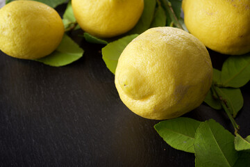 Close-up of lemons on a slate surface - 784497147