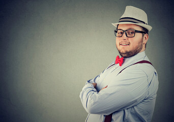 Confident happy young man in hat and glasses  - 784497566