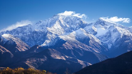 Obraz premium capped mountain range against a clear, blue sky