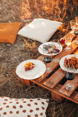 Wooden table with glassware arranged for picnic