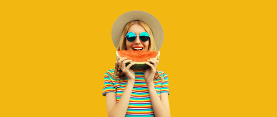 Summer portrait of happy young woman eating fresh slice of watermelon on yellow studio background