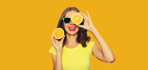 Summer vacation portrait of happy young woman with fresh fruits, slice orange on yellow background