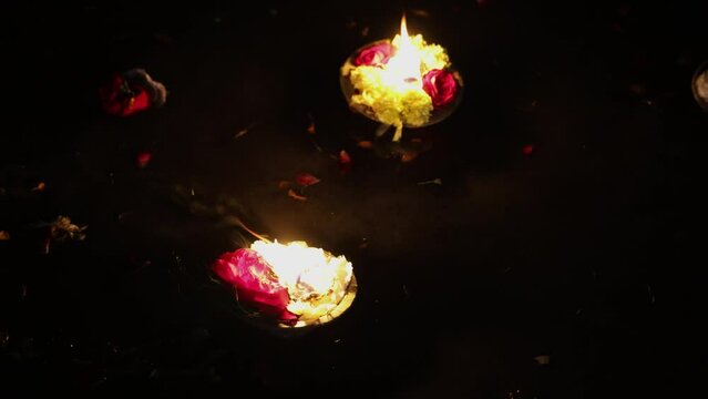 holy offerings oil lamp at river shore on religious occasion at night from different angle