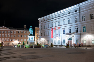 Salzburg, Austria, August 15 2022. Fascinating night shot in Mozart square. To the right of the Mozart statue is the city museum.
