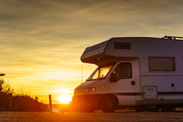 Camper car on beach at sunrise - 784509793
