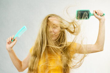 Girl blowing hair with comb brush - 784514186