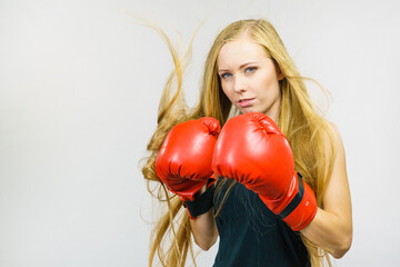 Woman in gloves playing sports boxing