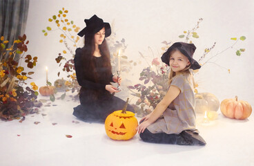 Charming woman and girl in Halloween costumes