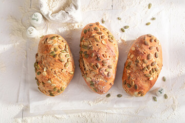 Golden and hot buns with pumpkin seeds at baker's place.