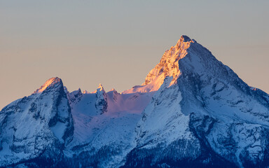 Watzmann mountain in Bavaria, Germany. Alpenglow with the first morning light in winter.