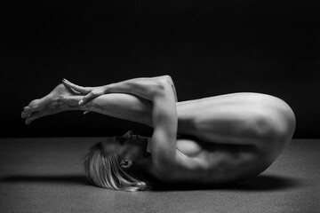 Art black and white photo of naked beautiful woman. Beauty nude yoga girl posing on black...