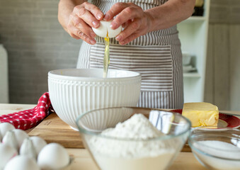 Place a cracked raw egg in a bowl for making a dough or batter