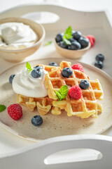 Homemade and delicious waffles with with raspberries and blueberries.