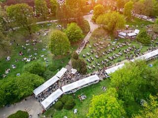city street food festival event at green park at summer, tents of food market at green meadow,...