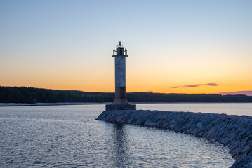 The old lighthouse of Vuohensalo on the background of sunset. Leningrad region, Russia - obrazy, fototapety, plakaty