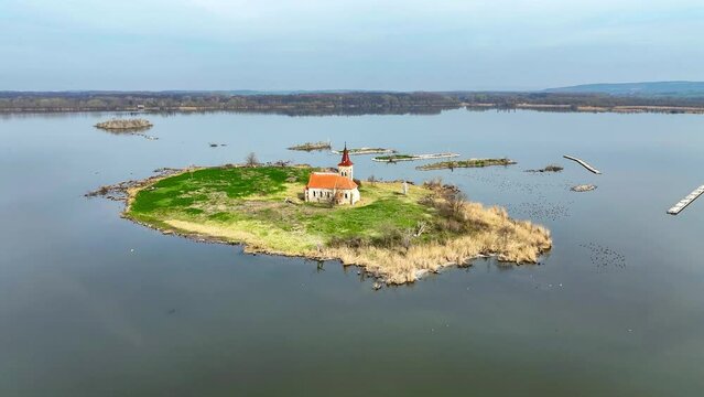 Musov Island in South Moravia, Czech Republic, with medieval Gothic saint Linhart (Leonard) church, now abandoned, after the village was flooded by the Nowe Mlyny (New Mills) dam lake. Aerial video