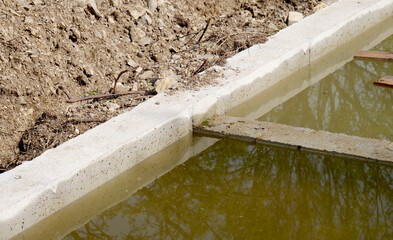 Reinforced concrete foundation base on rough terrain with wooden boards