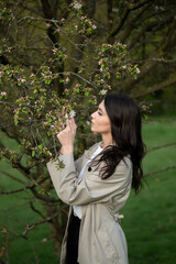 Beautiful women enjoying blossoming apple tree