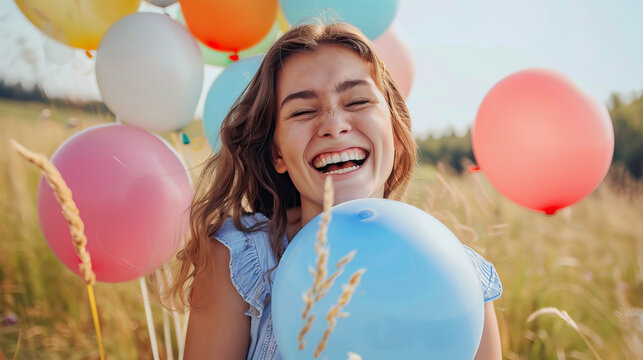 Carefree Laughter: Young Woman Playing with Colorful Balloons in a Field, Embracing Freedom.