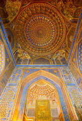 Fototapeta na wymiar Samarqand, Uzbekistan - April - 04 - 2024: Interior with gold and blue colors of the Tillya-Kori Madrasah in the centre of Samarqand in Uzbekistan.