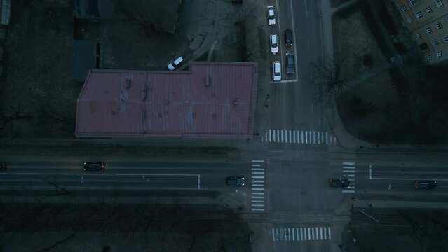 Aerial view of city street at night with red building in center