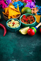 Traditional Mexican food nachos, salsa, guacamole, tequila.