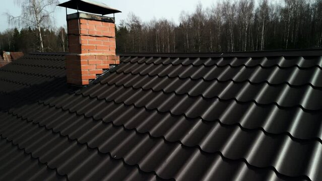 Close up of a roof with chimney made of brickwork on house