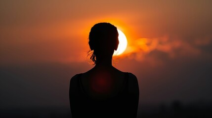 Silhouette against a setting sun, feeling overwhelmed, yet hopeful