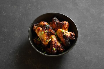 Grilled chicken wings in bowl. Close up view