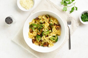 Farfalle pasta with roasted broccoli and mushrooms in bowl - obrazy, fototapety, plakaty