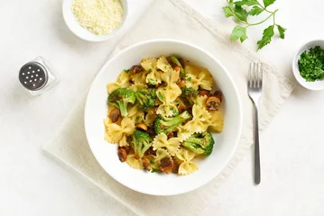 Poster Farfalle pasta with roasted broccoli and mushrooms in bowl © voltan