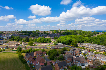 Aerial photo of the village of Pudsey in Leeds West Yorkshire in the UK, showing a typical British streets and houses, church and roads taken with a drone on a sunny summers day