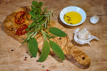Herbs, spices, chili, sun-dried tomatoes, garlic and olive oil for Mediterranean cuisine.