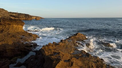 Ocean waves crashing on a rocky shore